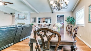 A dining area with a long wooden table, ornate chairs, and a chandelier. - Kindness - Wheelchair Accessible,BOK cent, Expo Sq (Tulsa)