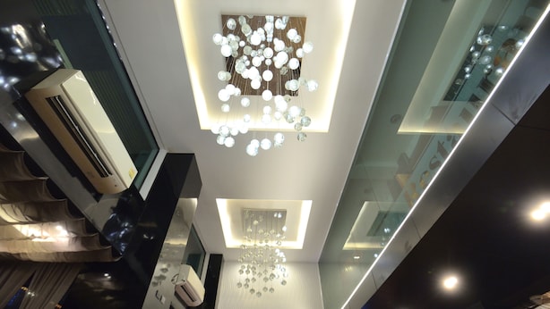 A modern interior with a unique ceiling design featuring spherical light fixtures and a central rectangular light panel. - De Lux Bangkok Hotel (Bangkok)