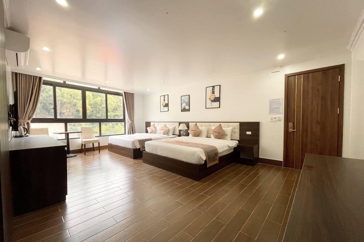 Habitación cuádruple ejecutiva | Sábanas de algodón egipcio y ropa de cama de alta calidad