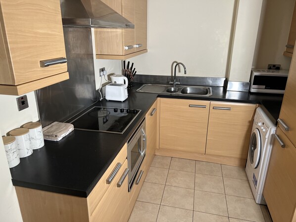Full-sized fridge, microwave, stovetop, dishwasher
