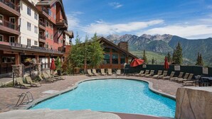 A pool area with lounge chairs and a mountain view. - Pinnacle Place Ski-In/Out | Views, Fireplace, Covered Parking, Deck, Hot Tub (Durango)