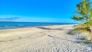A sandy beach with a clear blue sky and ocean. - Newly Remodeled Coastal Beachside Vacation Rental!! (Indian Rocks Beach)