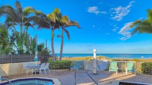 A pool area with two hot tubs, lounge chairs, and a view of the beach. - Newly Remodeled Coastal Beachside Vacation Rental!! (Indian Rocks Beach)