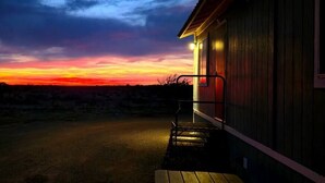 A building with a porch and a view of a sunset. - 038 Tiny Home nr Grand Canyon South Rim Sleeps 4 (Williams)