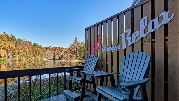 A wooden deck with Adirondack chairs and a sign that reads "Eat Dream Relax." - Lakeside Serenity, Lakeside Serenity (Jackson County)