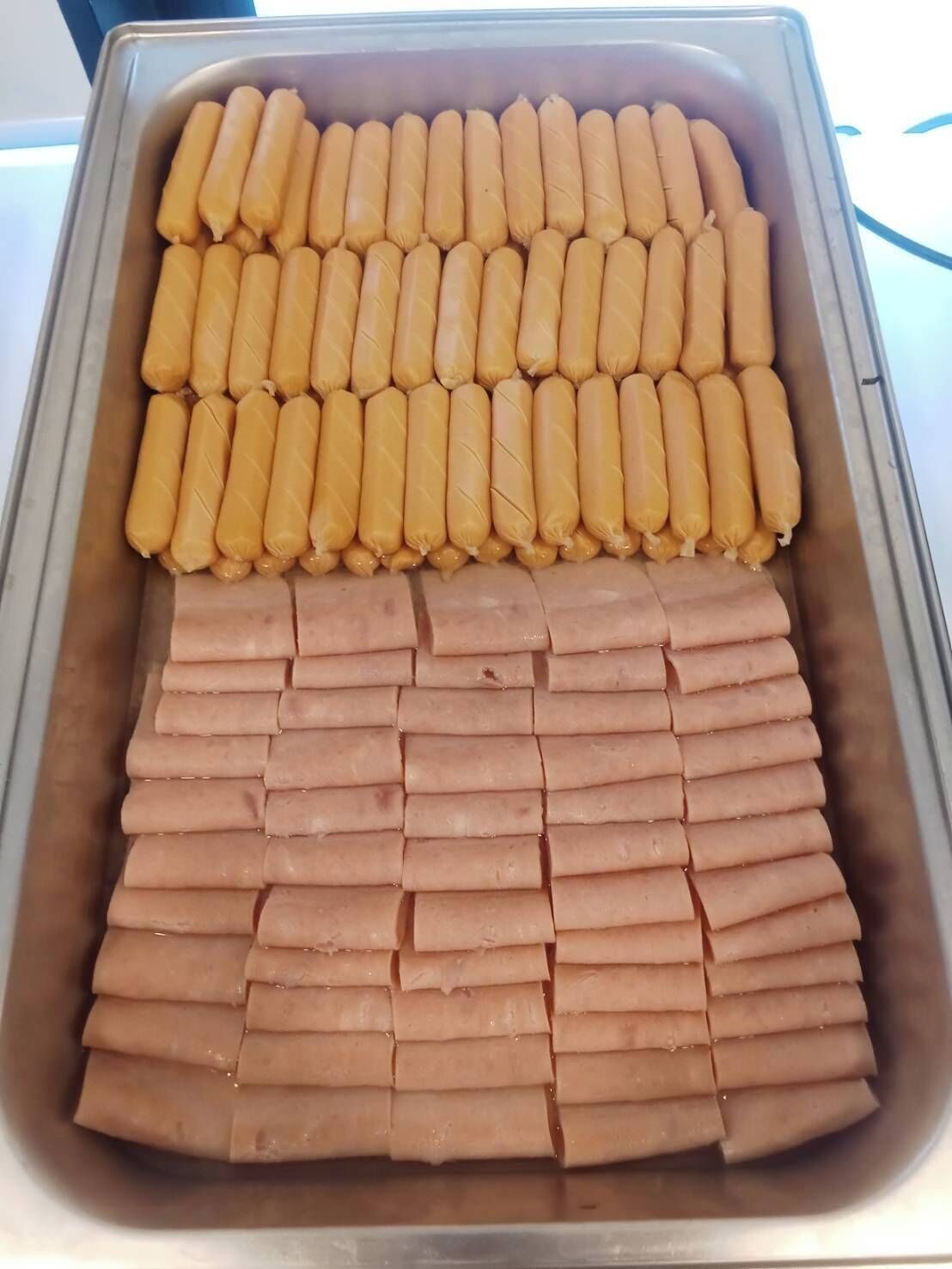 A tray with neatly arranged food items, possibly for a buffet or catering service.