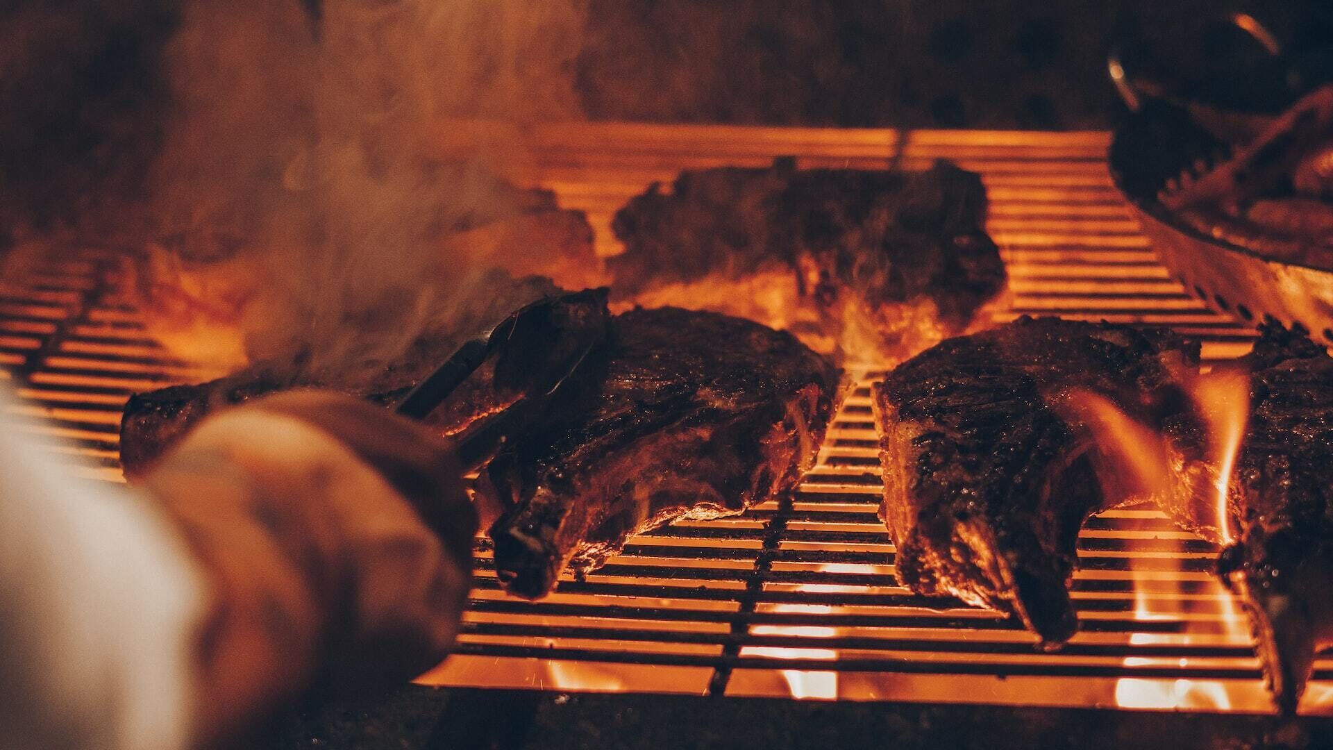 A grill with meat being cooked.