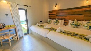 A hotel room with a large bed, a desk with a kettle, and a view of the outdoors. - Misty Villa by The Serendipity Collection (Ambagamuwa)
