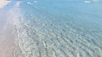 On the beach, white sand, beach towels, 15 beach bars