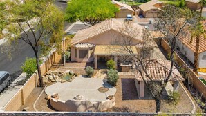 A residential area with a house featuring a patio, a swimming pool, and a small garden. - Pet-Friendly 3BR | King Bed | Fenced Yard (Tempe)