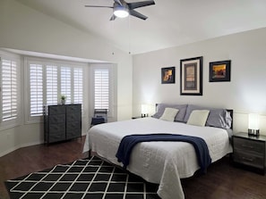 A bedroom with a bed, nightstands, a dresser, a ceiling fan, and a window with blinds. - Wow! 3BDR Single-story home in Tempe/Chandler (Tempe)