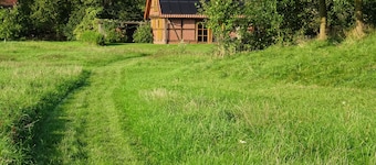 Vacation home with large meadow on nature reserve lake