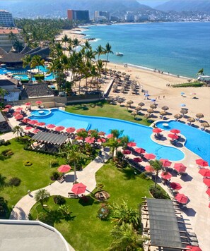 A resort with a large pool, beach, and ocean views. - GRAND VENETIAN, OCEAN FRONT CONDO (PUERTO VALLARTA)