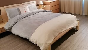 A bedroom with a bed, bedside tables, a lamp, a framed picture on the wall, and a window with curtains. - Beautiful and Modern Apartment in North London (London)