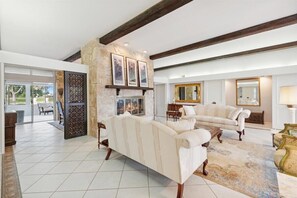 A spacious living room with a fireplace, two sofas, and a large rug. - Perfect golf course retreat for your Super Bowl / Phoenix Open stay (Sun City)
