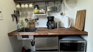 Fridge, microwave, coffee/tea maker, cookware/dishes/utensils