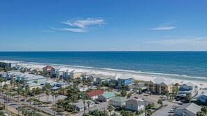 A coastal residential area with houses, a beach, and the ocean.