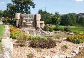 Enter a serene oasis at Stonebridge, surrounded by lush greenery and a tranquil waterfall.