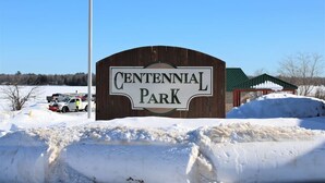 A wooden sign for Centennial Park with a clear blue sky in the background. - Couples Getaway & Business Travel- 6 Miles to MTU (Chassell)