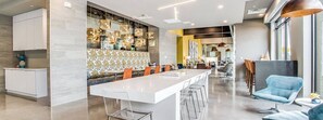Enjoy meals in this stylish kitchen with a central island, pendant lights, and a dining area.