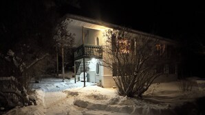 A house with a covered porch and a staircase leading to the entrance.