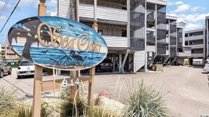 A building with a sign reading "Sea Oaks" and the number 814.