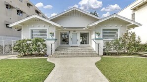 A two-story house with a front porch, a garage, and a small front yard.