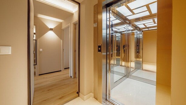 A modern elevator with glass doors and a lighted ceiling. - City Center Premium Apartment by Vacationy (Porto)