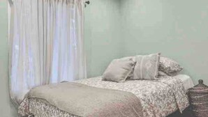 A bedroom with a bed, curtains, and a nightstand. - Hudson Valley Hilltop Escape w/Hot Tub, 5private acres, near wine trail, orchard (Marlboro)