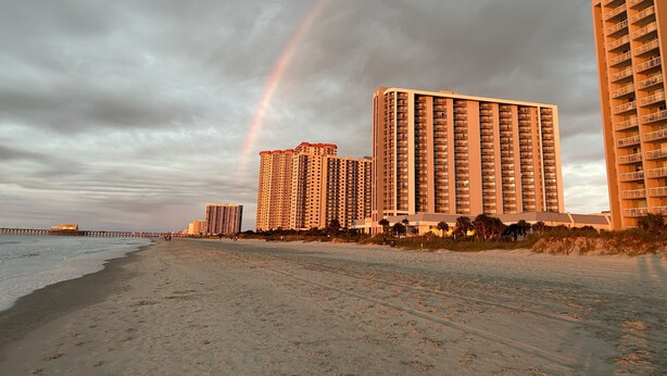 A beach with high-rise buildings and a visible rainbow. - Quiet Beach Getaway (Myrtle Beach)