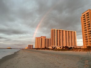A beach with high-rise buildings and a visible rainbow. - Quiet Beach Getaway (Myrtle Beach)