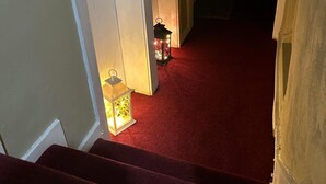 A staircase with a red carpet leading to a room. - Fabulous Apartment to Acton Town (London)