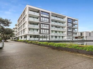 Stylish building with a symmetrical facade and balconies on each floor.