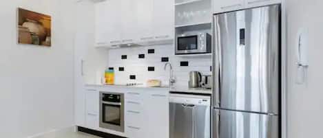 Apartment | Private kitchen | Fridge, microwave, stovetop, cookware/dishes/utensils