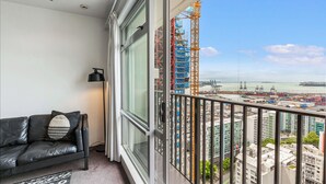 A balcony with a view of a construction site and port.