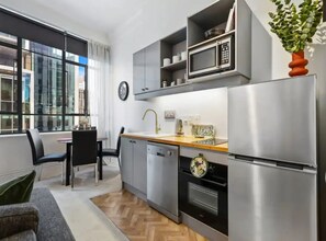 Apartment | Private kitchen | Fridge, microwave, stovetop, cookware/dishes/utensils