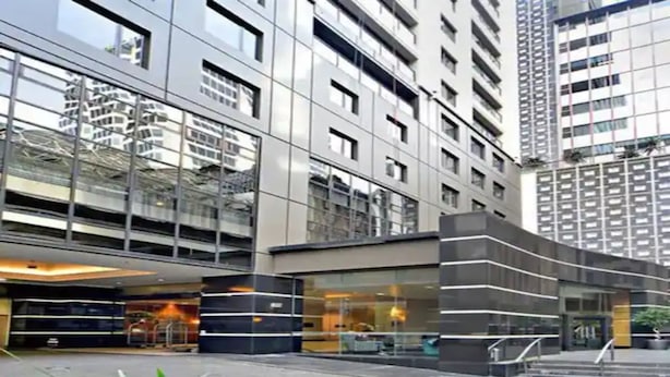 A modern building with a glass facade and multiple floors.