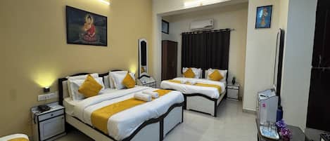 A hotel room with two beds, a desk, a chair, a mirror, and a painting on the wall.