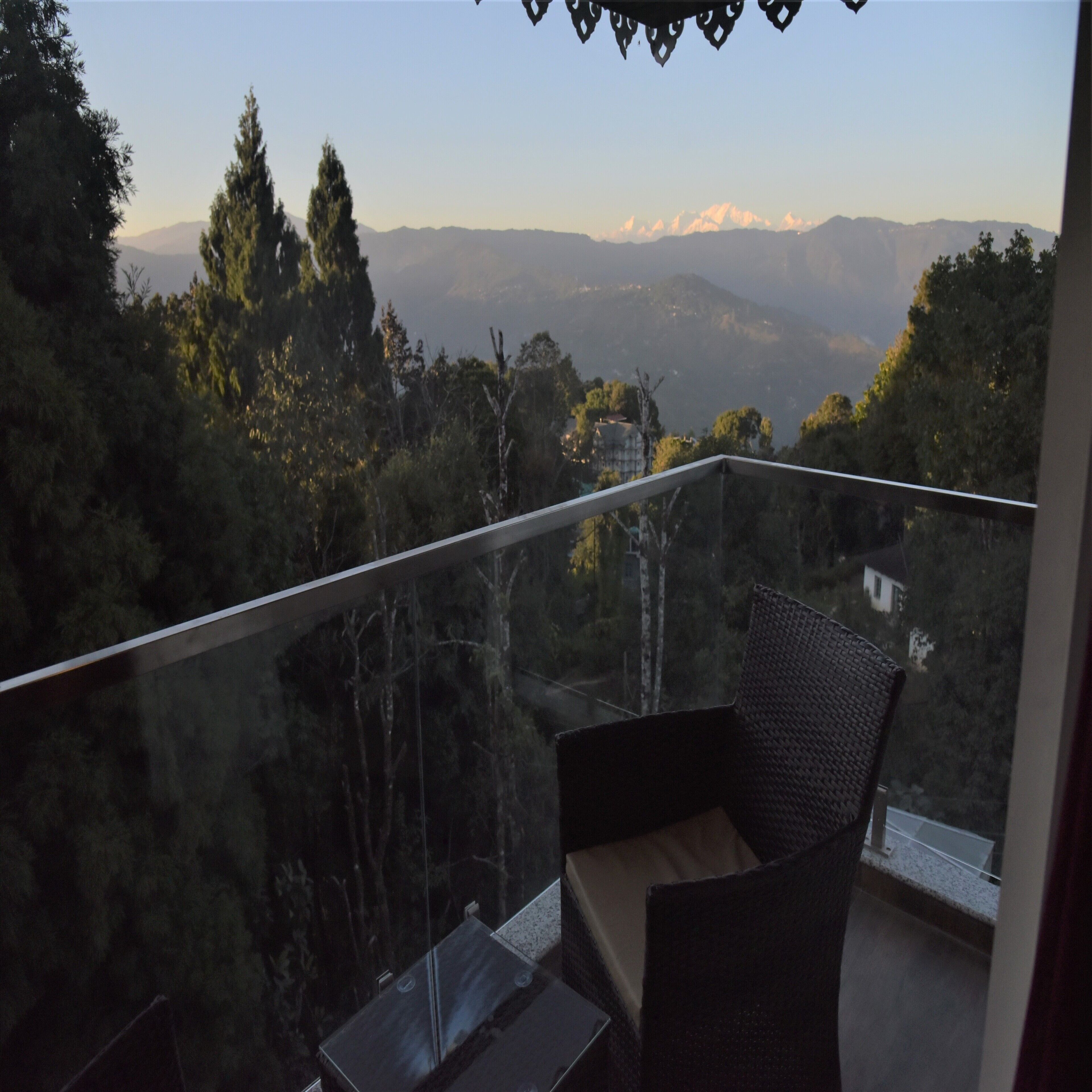 A balcony with a view of a mountainous landscape.