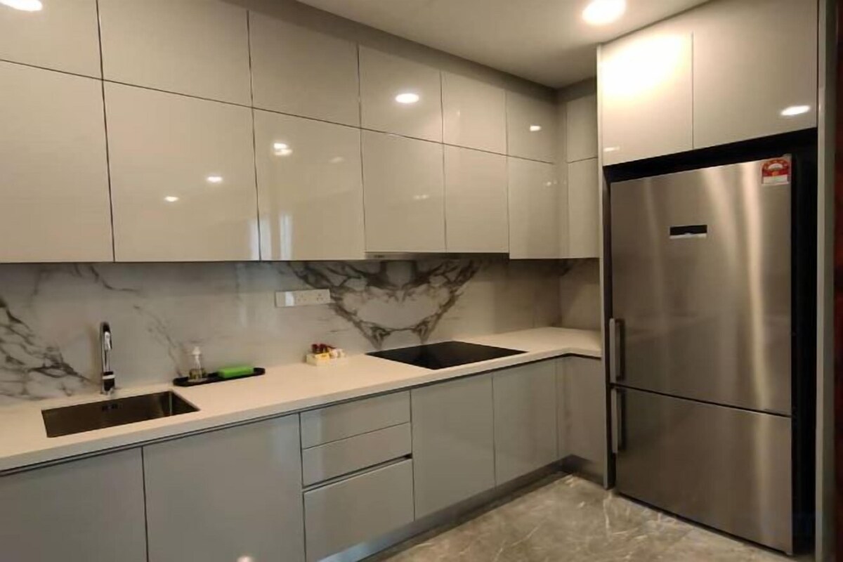 Cucina con schienale in marmo, elettrodomestici in acciaio inossidabile e un lavello doppio.