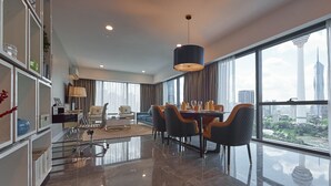 A modern hotel room with a dining area, large windows, and a city view. - THE FACE Style Hotel (Kuala Lumpur)