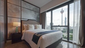 A modern hotel room with a large bed, a nightstand with a lamp, and a view of a cityscape through large windows. - THE FACE Style Hotel (Kuala Lumpur)