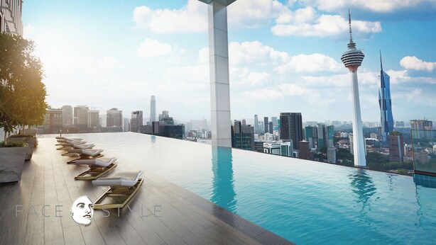 A rooftop infinity pool with lounge chairs, a city skyline view, and a modern tower structure. - THE FACE Style Hotel (Kuala Lumpur)