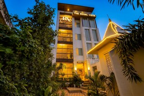 A hotel named 'The Royal Vista' with a modern facade, large windows, and a well-lit entrance. - HOTEL THE ROYAL VISTA (Varanasi)