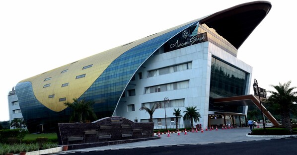 Aureum Grand features a distinctive curved facade and prominent entrance.