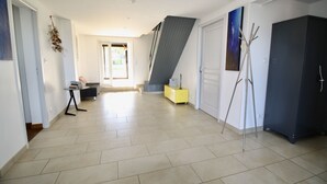 A spacious hallway with a tiled floor, a staircase, a yellow cabinet, and a dark wardrobe. - Unit 1291248 - SWEET HOME OF THE VINES - (Rully)