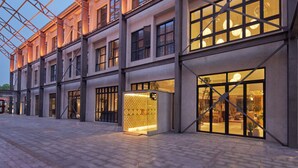 A modern building with large windows and a covered walkway. - Yitel Hotel Shanghai ex Timeless Boutique House (Shanghai)