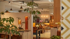 A modern interior with wooden furniture, potted plants, and pendant lighting. - Yitel Hotel Shanghai ex Timeless Boutique House (Shanghai)