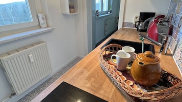 Fridge, stovetop, dishwasher, coffee/tea maker