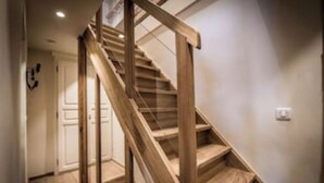 A wooden staircase with a simple design, leading to an upper floor. - Chalet Les Carlines (Courchevel)